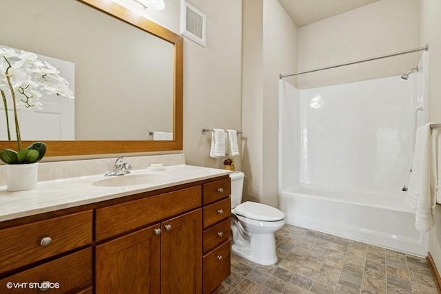 1370 SW Magazine Rd Unit 101, Ankeny, IA 50023 - bathroom featuring toilet, visible vents, shower / washtub combination, stone finish flooring, and vanity