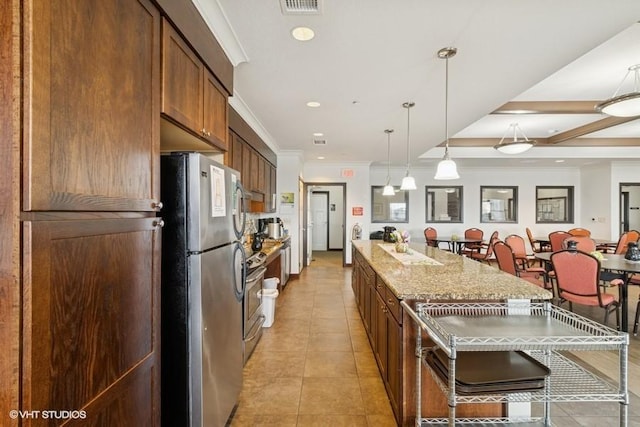 1370 SW Magazine Rd Unit 101, Ankeny, IA 50023 - kitchen featuring a center island, light tile patterned floors, pendant lighting, appliances with stainless steel finishes, and ornamental molding