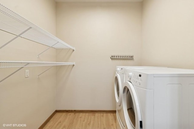 1370 SW Magazine Rd Unit 101, Ankeny, IA 50023 - laundry area with baseboards, washer and clothes dryer, laundry area, and light wood-style floors