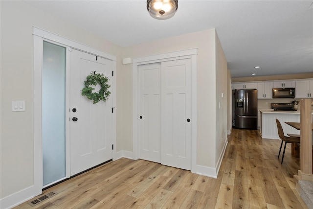 3121 NW 27th Cir, Ankeny, IA 50023 - foyer with light wood finished floors, baseboards, and recessed lighting