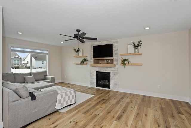 3121 NW 27th Cir, Ankeny, IA 50023 - living area with hardwood / wood-style flooring, a large fireplace, a ceiling fan, baseboards, and recessed lighting