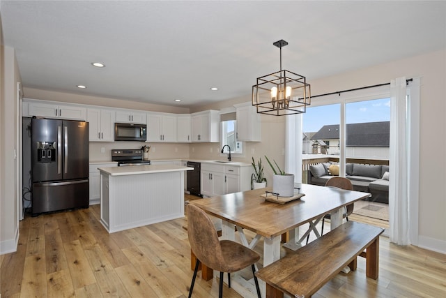 3121 NW 27th Cir, Ankeny, IA 50023 - dining area with a chandelier, light wood-style flooring, recessed lighting, and baseboards