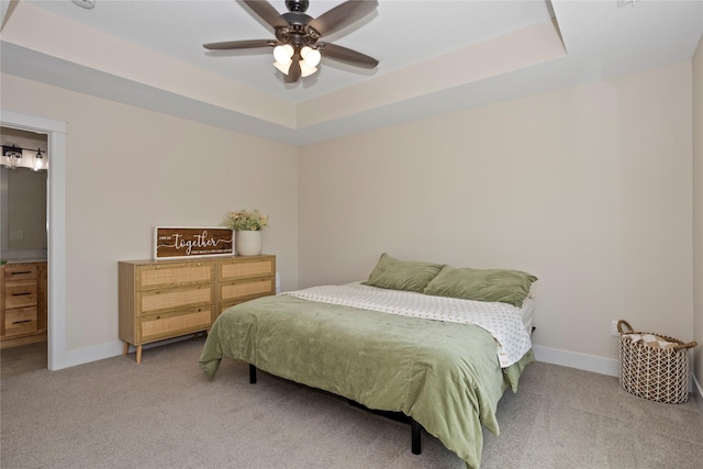 3121 NW 27th Cir, Ankeny, IA 50023 - carpeted bedroom featuring baseboards, a raised ceiling, ceiling fan, and connected bathroom