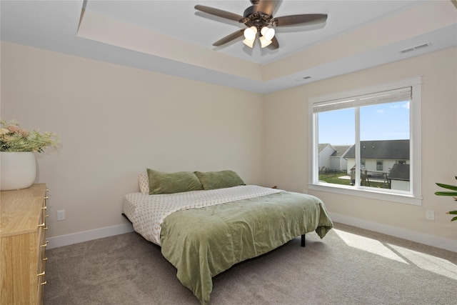 3121 NW 27th Cir, Ankeny, IA 50023 - bedroom featuring a tray ceiling, carpet, baseboards, and a ceiling fan