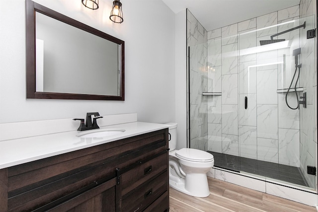 16318 Goldenrod Dr, Urbandale, IA 50323 - full bathroom featuring toilet, wood finished floors, vanity, and a marble finish shower