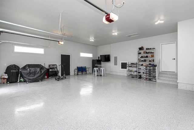 16318 Goldenrod Dr, Urbandale, IA 50323 - garage featuring electric panel and a garage door opener