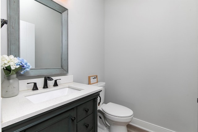 16318 Goldenrod Dr, Urbandale, IA 50323 - bathroom featuring toilet, vanity, and wood finished floors