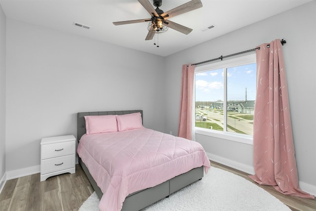 16318 Goldenrod Dr, Urbandale, IA 50323 - bedroom with ceiling fan, visible vents, baseboards, and wood finished floors