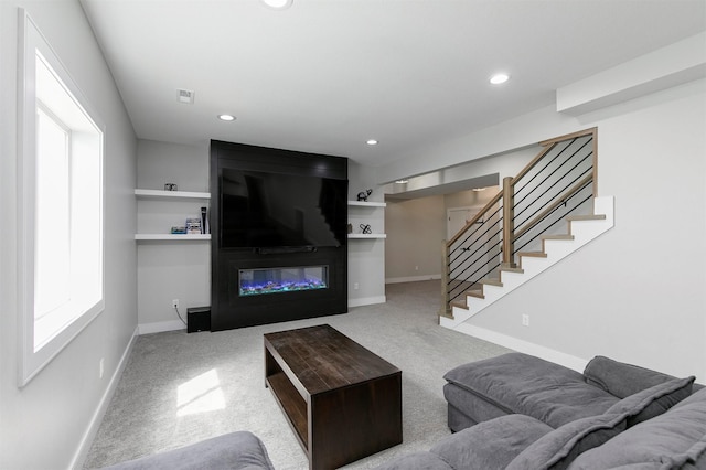 16318 Goldenrod Dr, Urbandale, IA 50323 - living room with baseboards, a large fireplace, stairway, and carpet floors