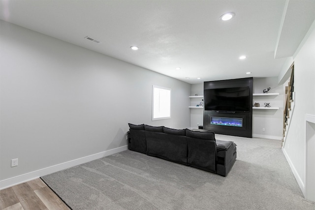 16318 Goldenrod Dr, Urbandale, IA 50323 - living area with a fireplace, visible vents, recessed lighting, wood finished floors, and baseboards