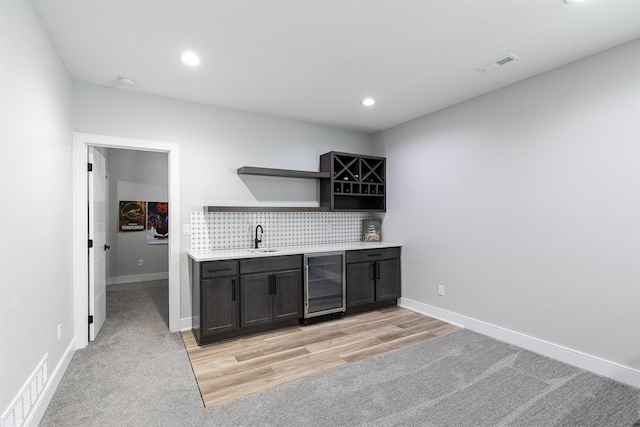 16318 Goldenrod Dr, Urbandale, IA 50323 - bar featuring visible vents, a sink, wet bar, and wine cooler