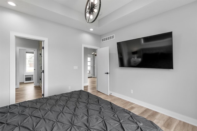 16318 Goldenrod Dr, Urbandale, IA 50323 - bedroom with a chandelier, wood finished floors, visible vents, and recessed lighting
