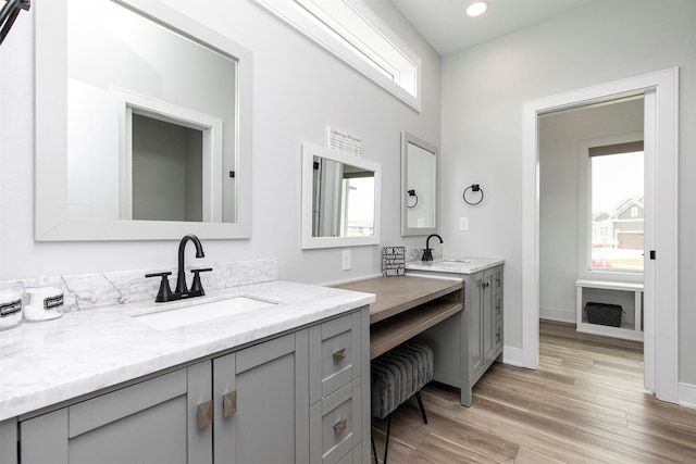 16318 Goldenrod Dr, Urbandale, IA 50323 - bathroom with wood finished floors, vanity, baseboards, and recessed lighting