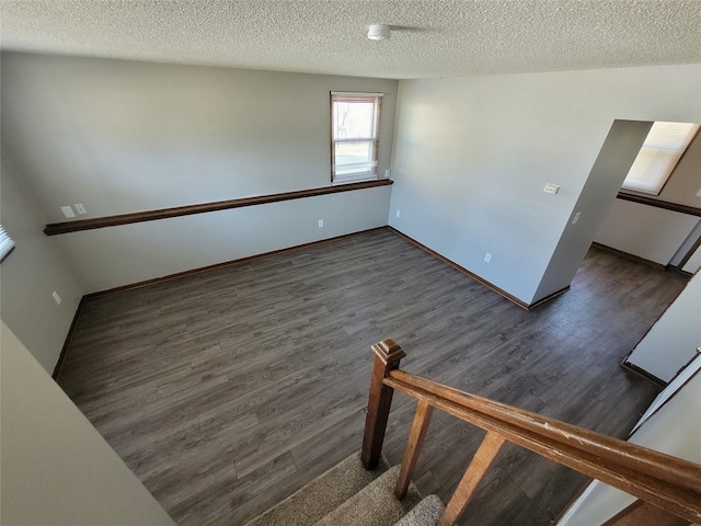 1761 E Lacona Ave, Des Moines, IA 50320 - interior space featuring a textured ceiling, baseboards, and wood finished floors