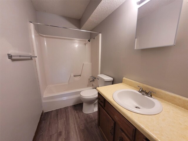 1761 E Lacona Ave, Des Moines, IA 50320 - bathroom with vanity, bathing tub / shower combination, a textured ceiling, toilet, and wood finished floors
