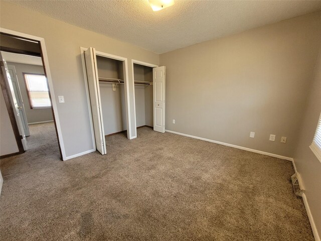 1761 E Lacona Ave, Des Moines, IA 50320 - unfurnished bedroom with a textured ceiling, a closet, multiple windows, and carpet
