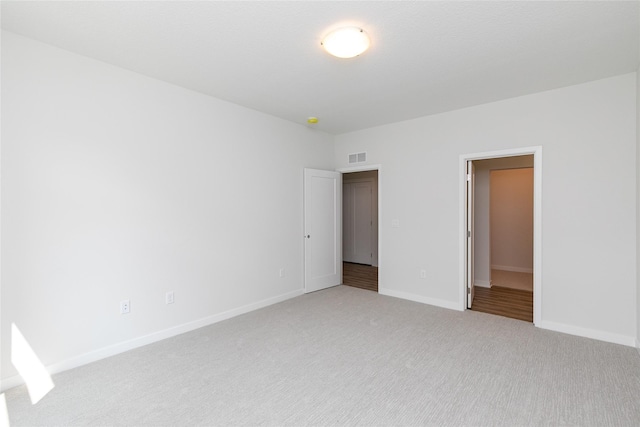 interior space featuring light carpet, baseboards, and visible vents