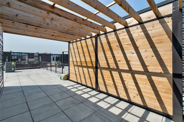 view of patio / terrace with cooling unit and a pergola