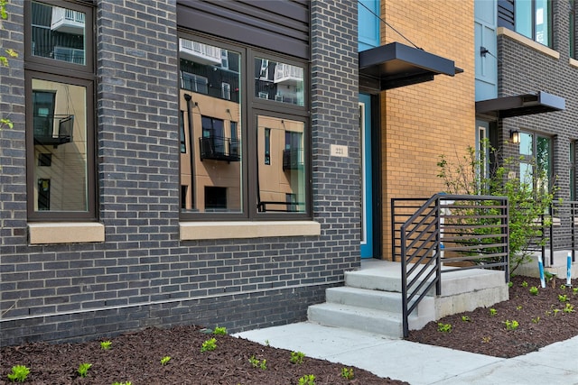 property entrance featuring brick siding