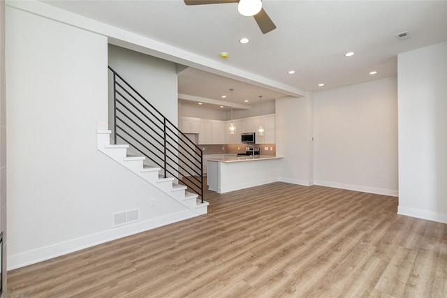 unfurnished living room featuring recessed lighting, visible vents, light wood-type flooring, and a ceiling fan