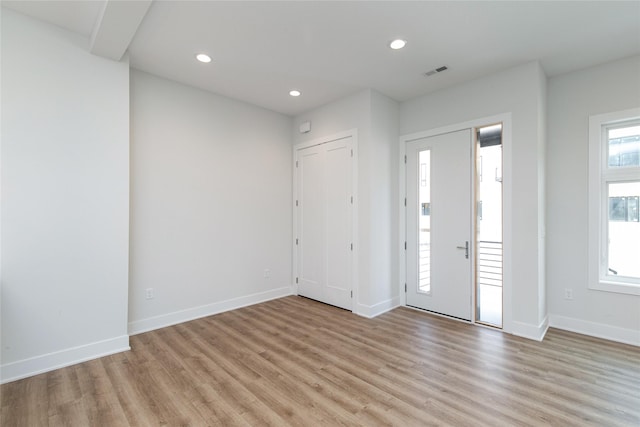 foyer featuring recessed lighting, light wood finished floors, visible vents, and baseboards