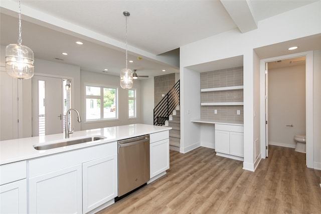kitchen with a sink, stainless steel dishwasher, recessed lighting, and light wood-style flooring