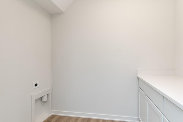 interior space featuring wood finished floors, vanity, and baseboards