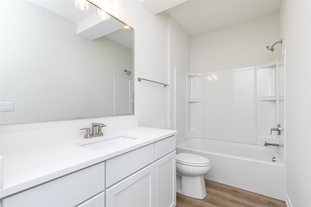 full bath with washtub / shower combination, toilet, vanity, and wood finished floors