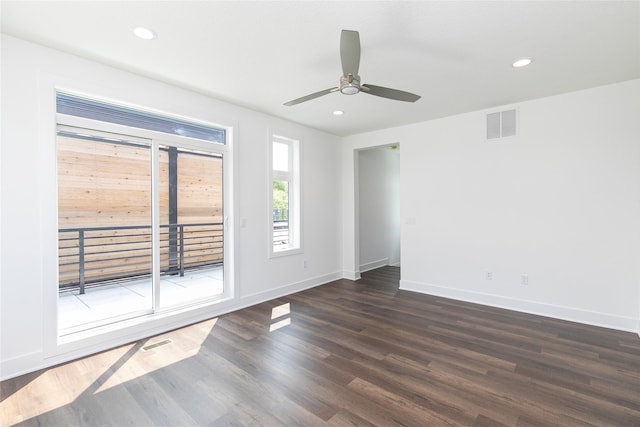 empty room featuring wood finished floors, ceiling fan, baseboards, and visible vents