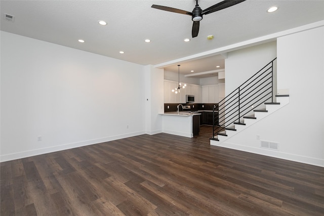 unfurnished living room featuring visible vents, recessed lighting, and dark wood-style floors