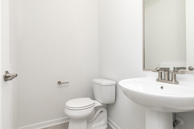 213 Maple St, Des Moines, IA 50309 - half bath with baseboards, toilet, and wood finished floors