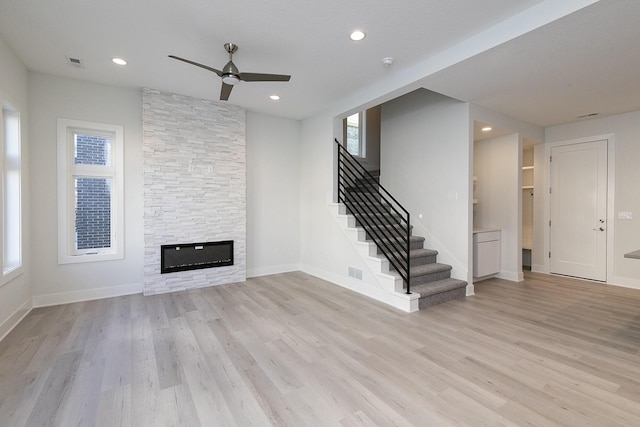 213 Maple St, Des Moines, IA 50309 - unfurnished living room with stairs, visible vents, light wood-type flooring, and a ceiling fan