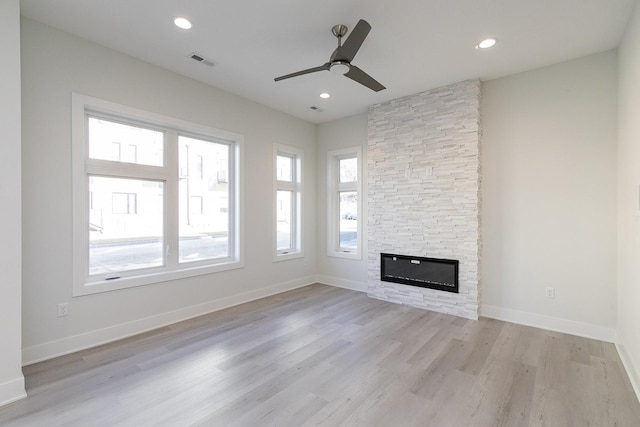 213 Maple St, Des Moines, IA 50309 - unfurnished living room with visible vents, baseboards, a ceiling fan, light wood-style floors, and a fireplace