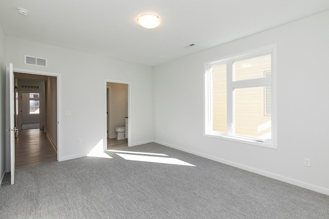 213 Maple St, Des Moines, IA 50309 - unfurnished bedroom with baseboards, carpet, visible vents, and ensuite bath