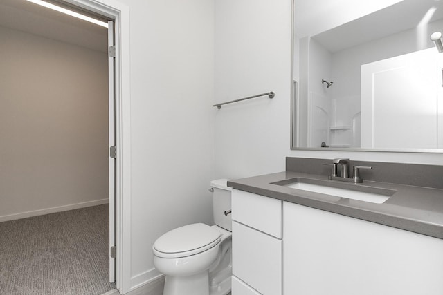 213 Maple St, Des Moines, IA 50309 - full bathroom with toilet, vanity, baseboards, and walk in shower