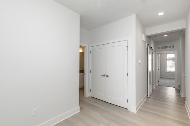 213 Maple St, Des Moines, IA 50309 - corridor with light wood-style floors, visible vents, recessed lighting, a barn door, and baseboards