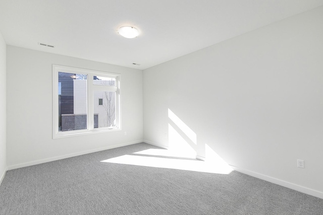 213 Maple St, Des Moines, IA 50309 - empty room with baseboards, visible vents, and carpet floors