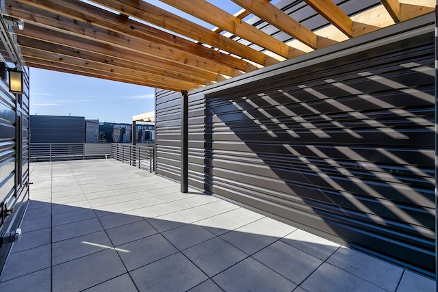 213 Maple St, Des Moines, IA 50309 - view of patio featuring a carport, a pergola, and a balcony