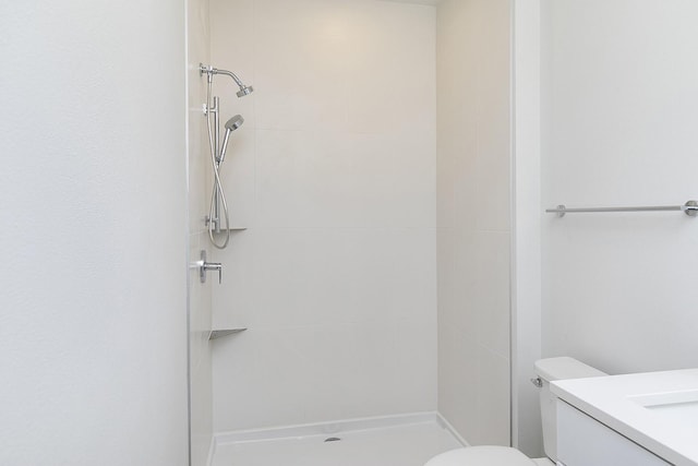 209 Maple St, Des Moines, IA 50309 - bathroom featuring a shower stall, vanity, and toilet
