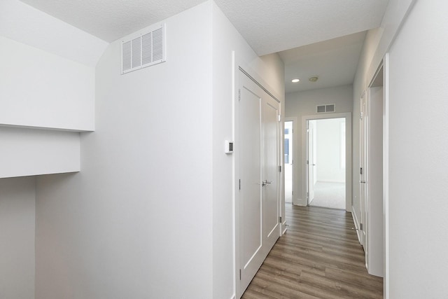 209 Maple St, Des Moines, IA 50309 - hall with wood finished floors, baseboards, visible vents, and recessed lighting