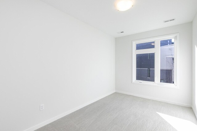 209 Maple St, Des Moines, IA 50309 - carpeted spare room with baseboards and visible vents