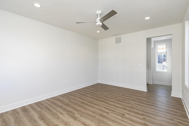 209 Maple St, Des Moines, IA 50309 - unfurnished room featuring visible vents, baseboards, a ceiling fan, and wood finished floors