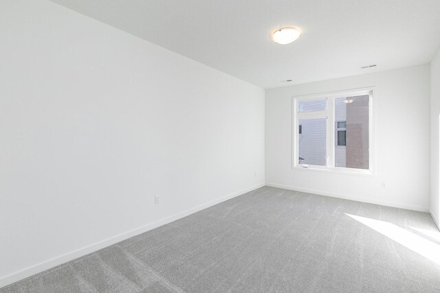 205 Maple St, Des Moines, IA 50309 - carpeted empty room featuring baseboards