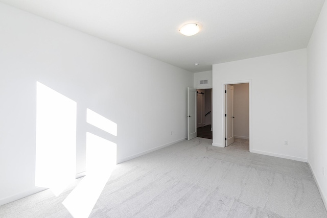 205 Maple St, Des Moines, IA 50309 - unfurnished bedroom with a walk in closet, visible vents, light colored carpet, and baseboards