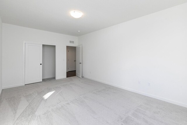 205 Maple St, Des Moines, IA 50309 - unfurnished bedroom with visible vents, baseboards, and light carpet