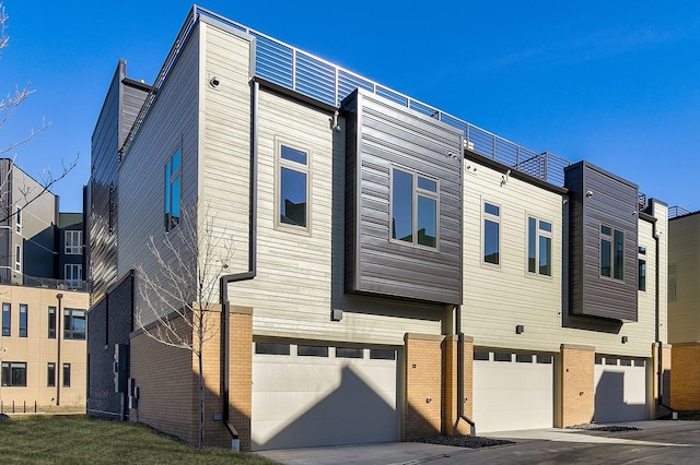 205 Maple St, Des Moines, IA 50309 - exterior space featuring a garage and brick siding