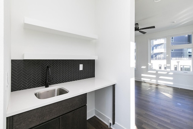 205 Maple St, Des Moines, IA 50309 - kitchen with a sink, light countertops, a ceiling fan, dark wood-style floors, and backsplash