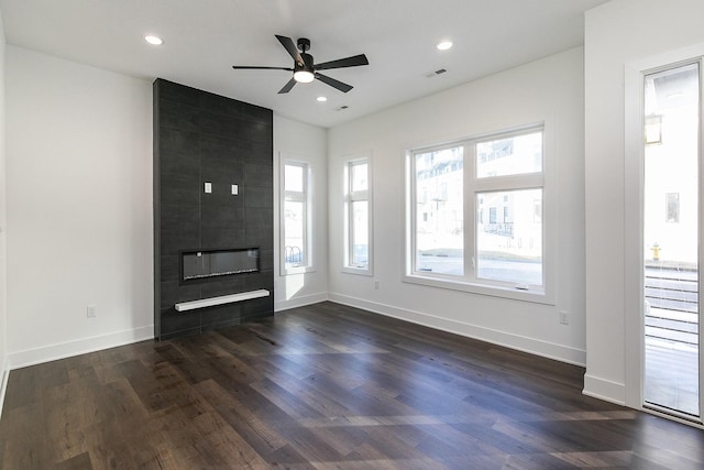 205 Maple St, Des Moines, IA 50309 - unfurnished living room featuring a fireplace, dark wood-style flooring, and ceiling fan