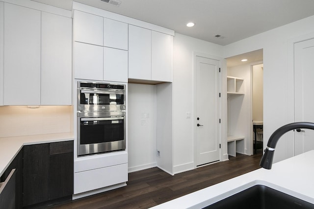 205 Maple St, Des Moines, IA 50309 - kitchen featuring dark wood finished floors, double oven, white cabinetry, recessed lighting, and light countertops