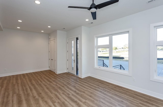 859 E 2nd St, Des Moines, IA 50309 - empty room featuring a healthy amount of sunlight, recessed lighting, and wood finished floors